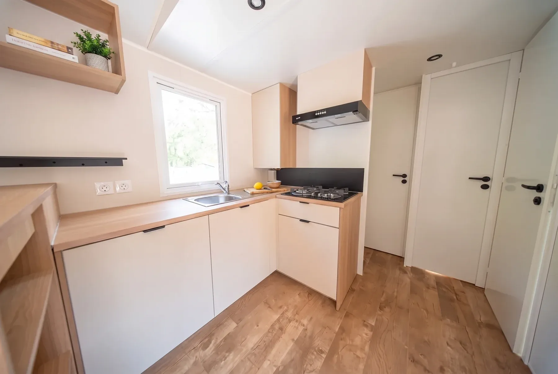 NEST 40.3 ARENA — La cuisine en L, éclairée par une fenêtre au-dessus de l’évier